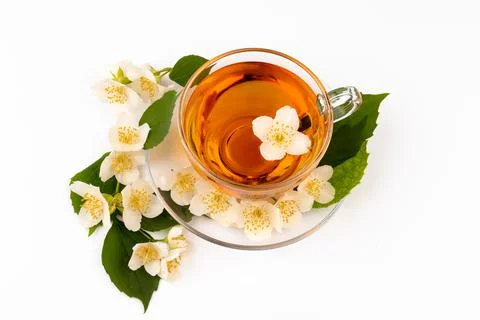 Composition with cup of jasmine tea and flowers on light background Foto stock