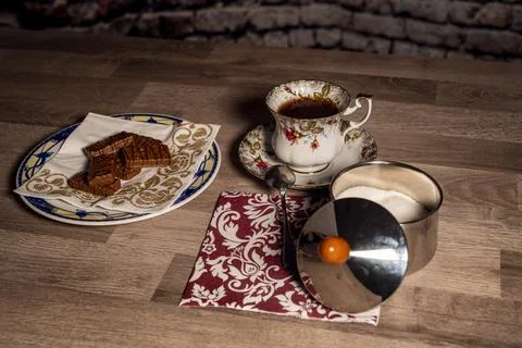 Composition cup tea biscuits with sugar bowl Stock Photos