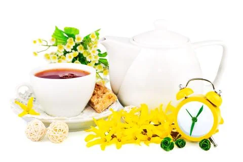 Composition from cup of tea, clock and spring flowers Stock Photos