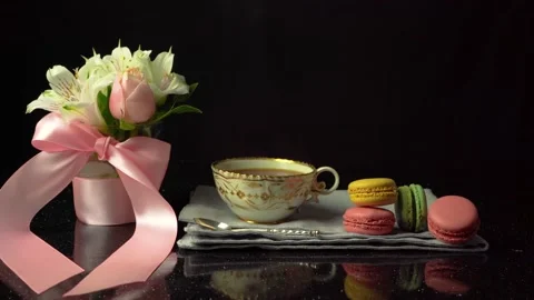 Composition of a cup of tea with macaroons and a bouquet of flowers, copy space Stock Footage 147874970