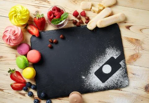Composition of desserts on a black stone background. Cakes with fruit and a c Stock Photos
