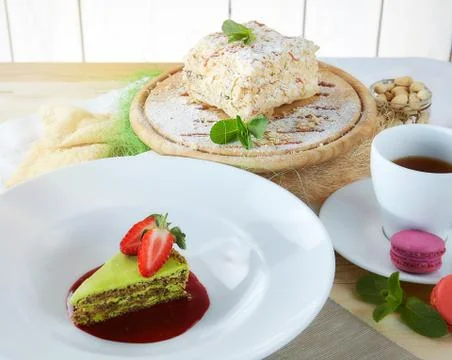 Composition of desserts on a light background. Cakes with fruit and a cup of  Stock Photos