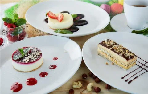 Composition of desserts on a light background. Cakes with fruit and a cup of  Stock Photos
