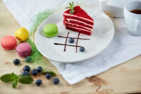 Composition of desserts on a light background. Cakes with fruit and a cup of  Stock Photos