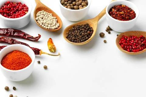 Composition with different aromatic spices in bowls and wooden spoons on white Stock Photos