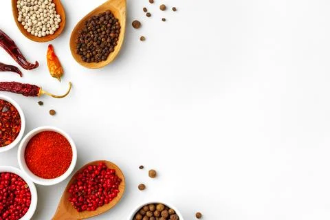Composition with different aromatic spices in bowls and wooden spoons on white Stock Photos