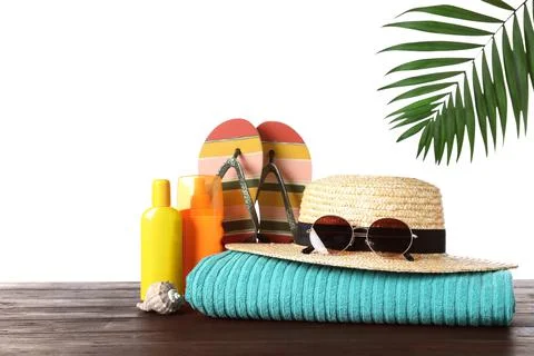 Composition with different beach objects on wooden table, white background Stock Photos