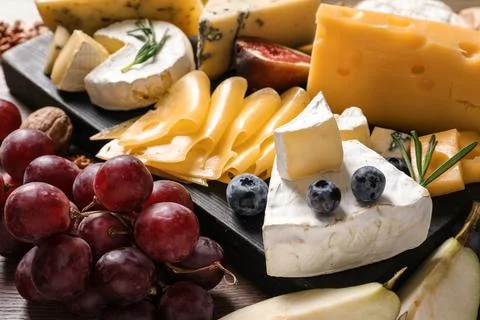 Composition with different delicious cheeses and fruits, closeup Stock Photos
