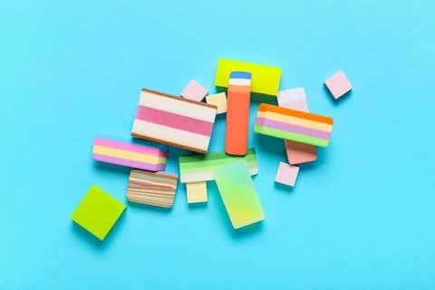 Composition with different erasers on color background 库存照片