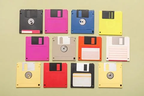 Composition with different floppy disks on green background Stock Photos