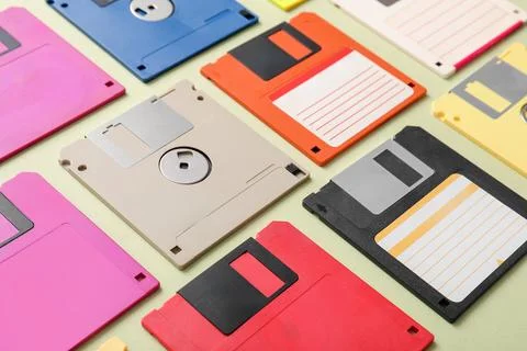 Composition with different floppy disks on green background Stock Photos