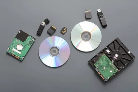 Composition with different memory storage devices on grey background Stock Photos