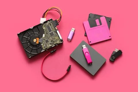 Composition with different memory storage devices on pink background Stock Photos