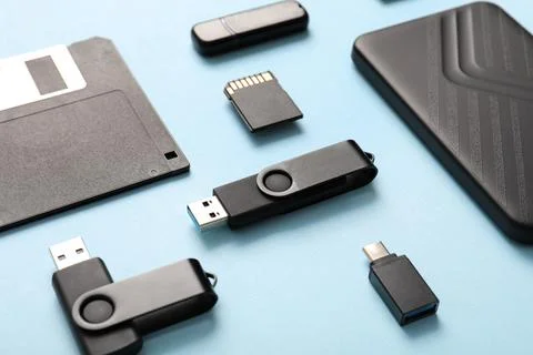 Composition with different memory storage devices on blue background Stock Photos