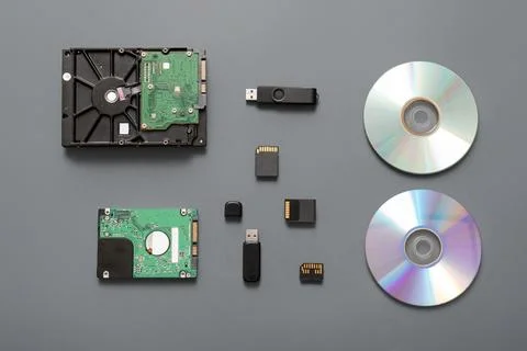Composition with different memory storage devices on grey background Stock Photos