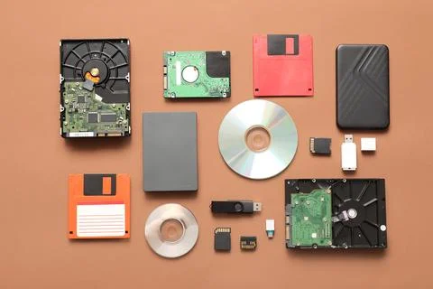 Composition with different memory storage devices on brown background Stock Photos