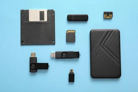 Composition with different memory storage devices on blue background Stock Photos
