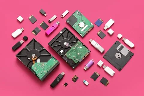 Composition with different memory storage devices on pink background 库存照片