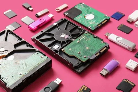 Composition with different memory storage devices on pink background Stock Photos