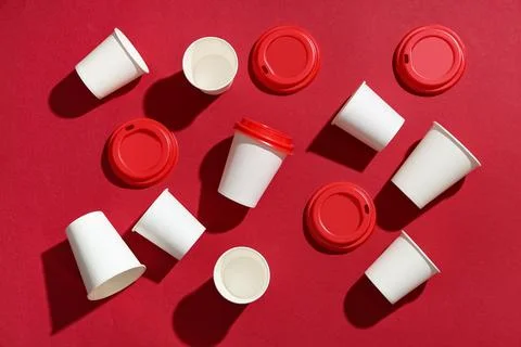 Composition with different paper cups and lids on red background Stock Photos