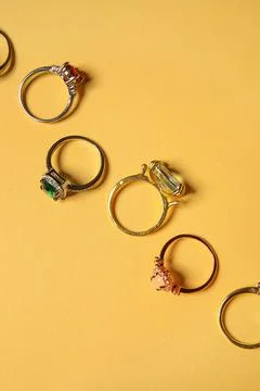 Composition with different rings on yellow background, closeup Stock Photos