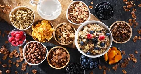 Composition with different sorts of breakfast cereal products and fresh fruit Stock Photos