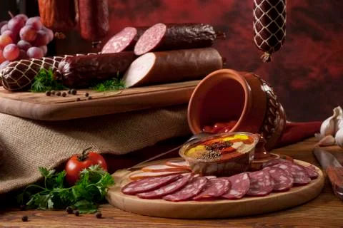 A composition of different sorts of sausages on the table. Stock Photos