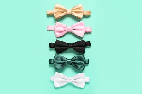 Composition with different stylish bow ties on mint background Stock Photos