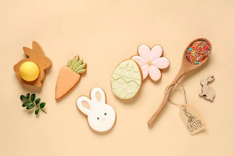 Composition with different tasty Easter cookies and sprinkles on beige backgr Stock Photos