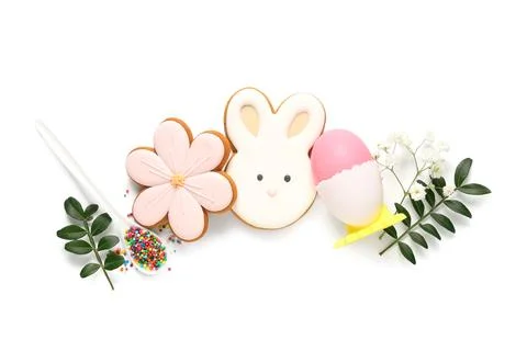 Composition with different tasty Easter cookies, egg, flowers and sprinkles i Stock Photos
