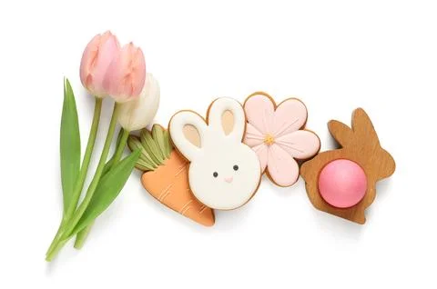 Composition with different tasty Easter cookies and tulip flowers isolated on Stock Photos