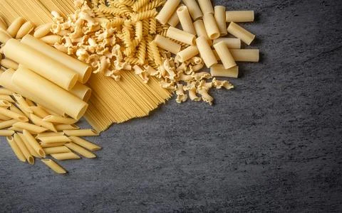 Composition with different tasty uncooked pasta - Italian pasta wallpaper, .. Stock Photos