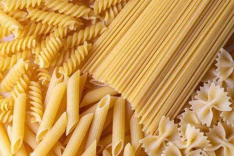 Composition with different tasty uncooked pasta - Italian pasta wallpaper, .. Stock Photos
