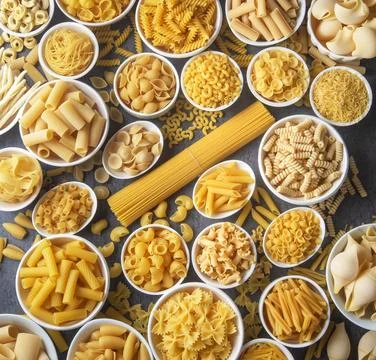 Composition with different tasty uncooked pasta - Italian pasta wallpaper, .. Stock Photos
