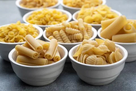 Composition with different tasty uncooked pasta - Italian pasta wallpaper, .. Stock Photos