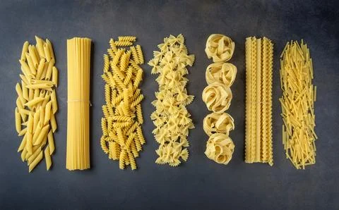 Composition with different tasty uncooked pasta - Italian pasta wallpaper, .. Stock Photos