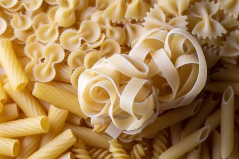 Composition with different tasty uncooked pasta - Italian pasta wallpaper, .. Stock Photos