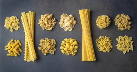 Composition with different tasty uncooked pasta - Italian pasta wallpaper, .. Stock Photos
