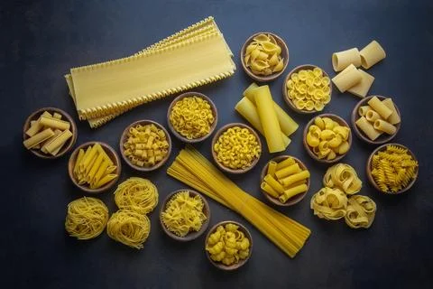 Composition with different tasty uncooked pasta - Italian pasta wallpaper, .. Stock Photos