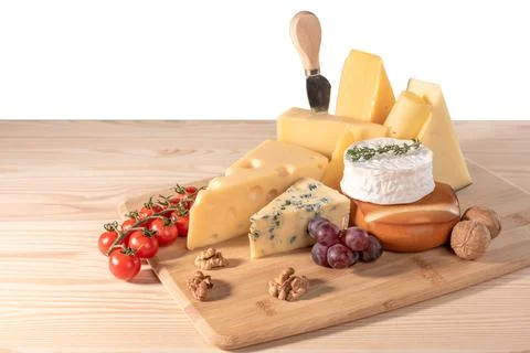 Composition different types of cheese with walnuts, tomato and grapes isolate 스톡 사진