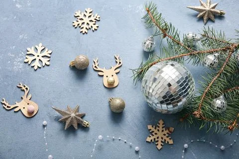 Composition with disco balls, fir tree branch and Christmas decor on blue gru Stock Photos