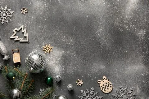 Composition with disco balls, fir tree branch and Christmas decor on black gr Stock Photos