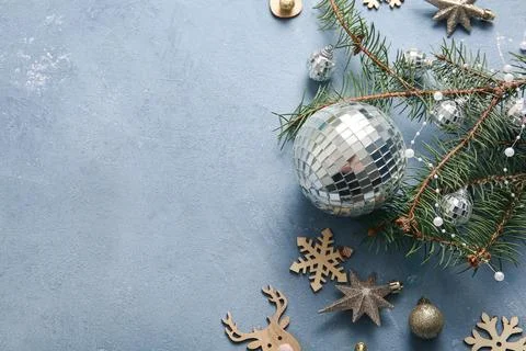 Composition with disco balls, fir tree branch and Christmas decor on blue gru Stock Photos