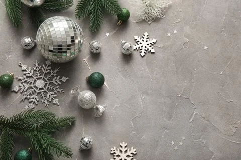Composition with disco balls, fir tree branches and Christmas decor on grey g Stock Photos