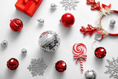 Composition with disco balls, gift box and Christmas decor on light pink back Stock Photos