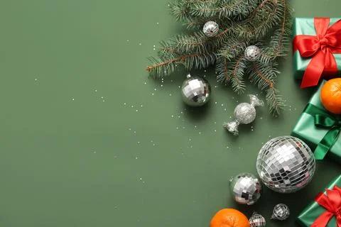 Composition with disco balls, gift boxes, tangerines and Christmas decor on g Stock Photos