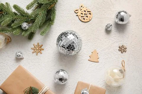 Composition with disco balls, gift boxes and Christmas decor on white grunge  Stock Photos