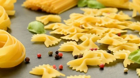 Composition of dry pasta, black pepper, basil and tomatoes Stock Footage 72583825