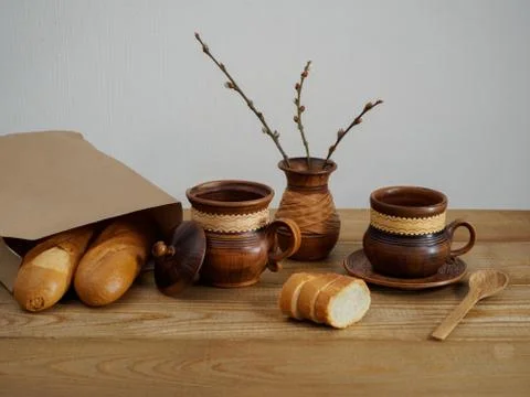 A composition of earthenware a cup, a plate, a vase, a jug of milk on a wooden Stock Photos