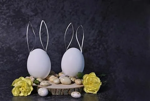 Composition with Easter eggs, easter bunny and branches on a black backgrou.. Stock Photos